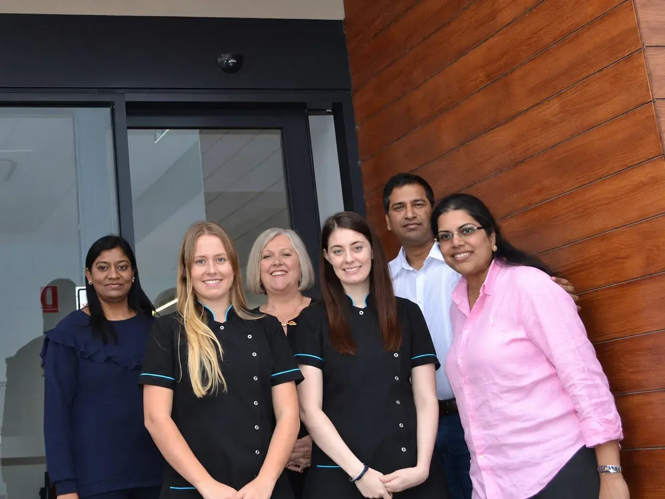 The Two Rocks Dental Care team outside the practice entrance